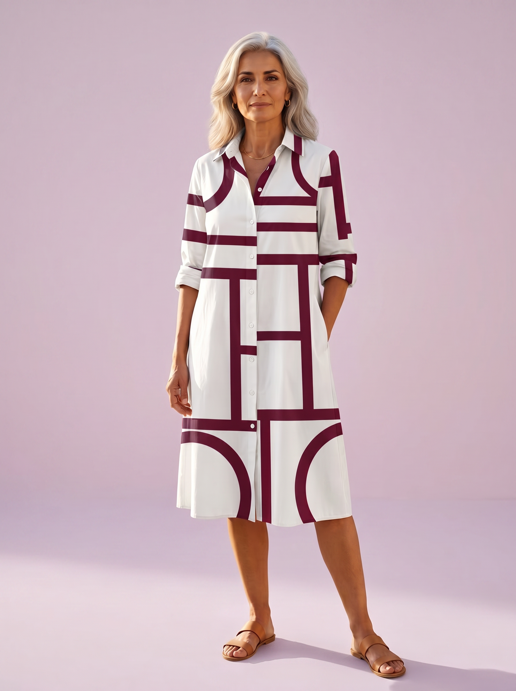 Elegant Spanish woman in her fifties in the white shirt dress with a wine-red geometric line print, studio shot on a lilac backdrop