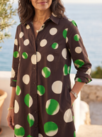 Close detail of the collar, button placket and oversized polka dots on the shirt dress