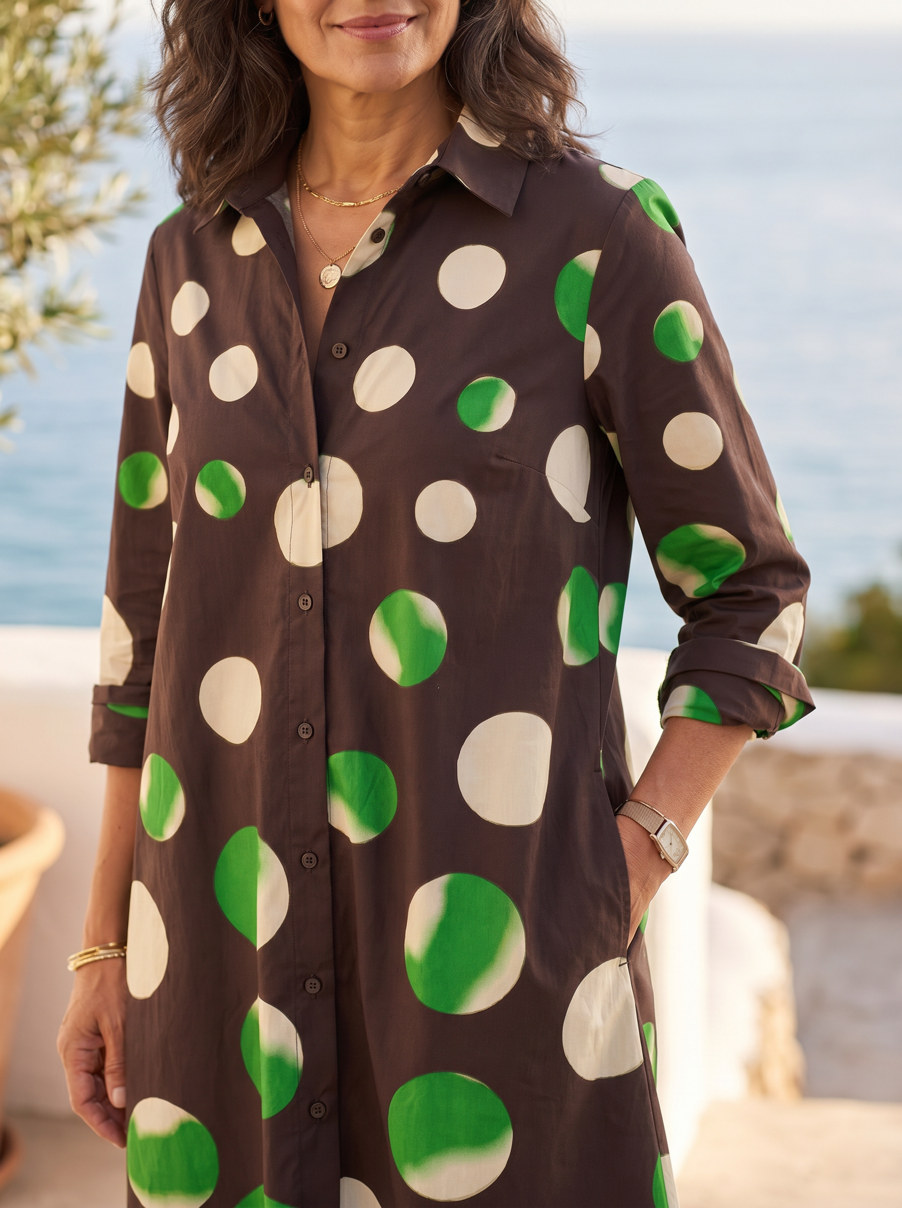 Close detail of the collar, button placket and oversized polka dots on the shirt dress