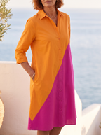 Close detail of the collar, placket and the diagonal seam where orange meets magenta on the colour-block shirt dress
